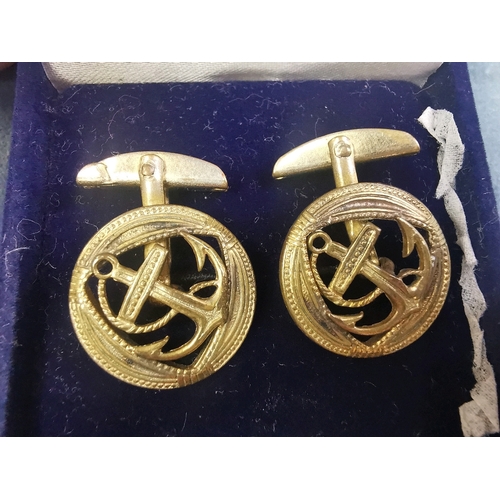 702 - Pair of white metal cuff links decorated with anchors.