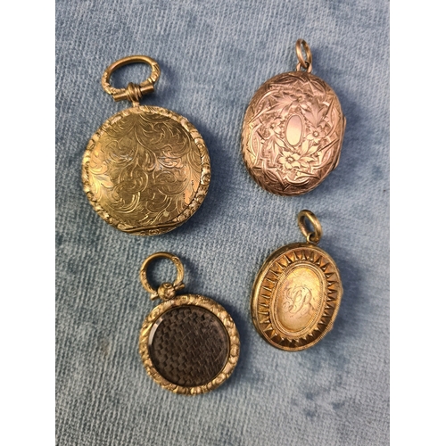 759 - 4 various yellow metal lockets. 2 are mourning lockets containing braided hair.