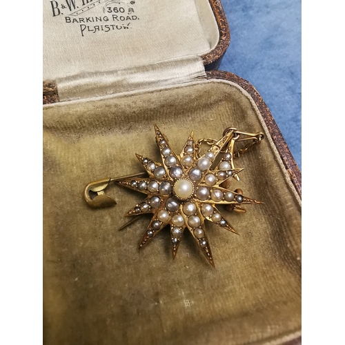 769 - Lovely Edwardian 9 carat gold star brooch with numerous graduated pearls decoration and safety chain... 