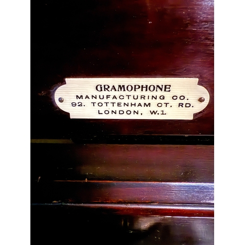 795 - A pretty mahogany gramophone complete with winding handle, spare needles and a variety of records.  ... 