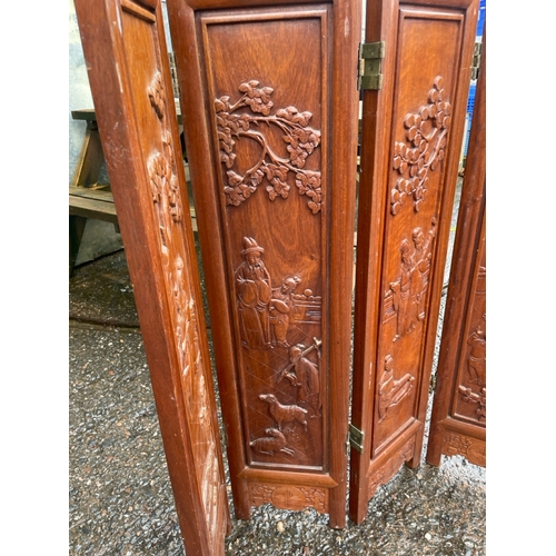 796 - Oriental hardwood 4 leaf folding screen with carved scenes to each leaf.  Appears to be just the bot... 