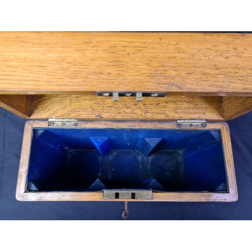 40 - Lockable wooden tantalus box containing three glass decanters, with key