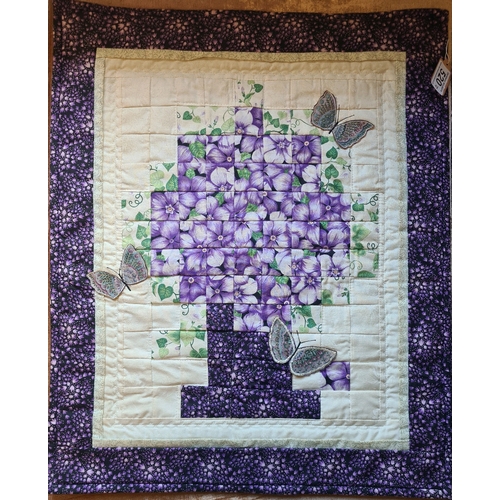 520 - Three quilted wall hangings with purple flower and butterfly designs. All measuring approx 50cm and ... 