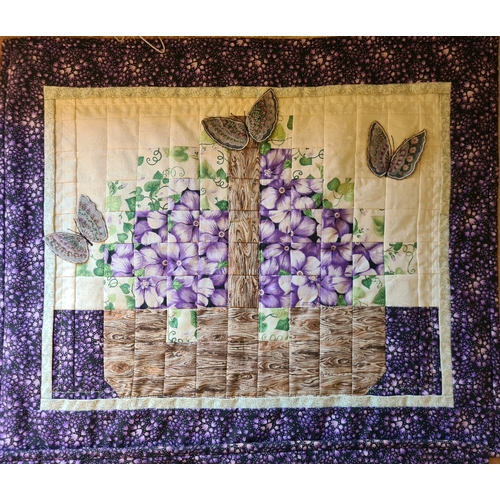 520 - Three quilted wall hangings with purple flower and butterfly designs. All measuring approx 50cm and ... 