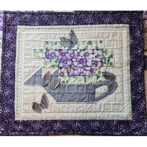 520 - Three quilted wall hangings with purple flower and butterfly designs. All measuring approx 50cm and ... 