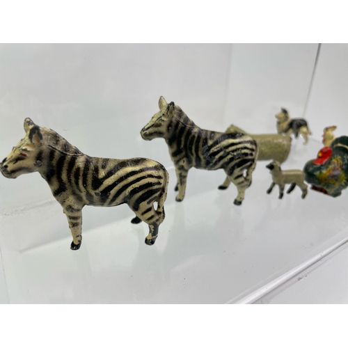 634 - Collection of vintage cast lead farm animals in Zebra, sheep, pigs, fab turkey and figure