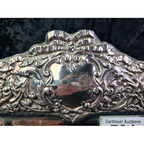 734 - Large ornate silver photo frame with leather back, Birmingham 1992, 31cm x 23cm