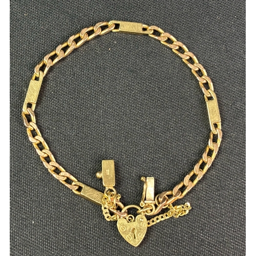 765 - Unusual 9ct gold padlock bracelet with safety chain. 20 cms long. 13gms weight.