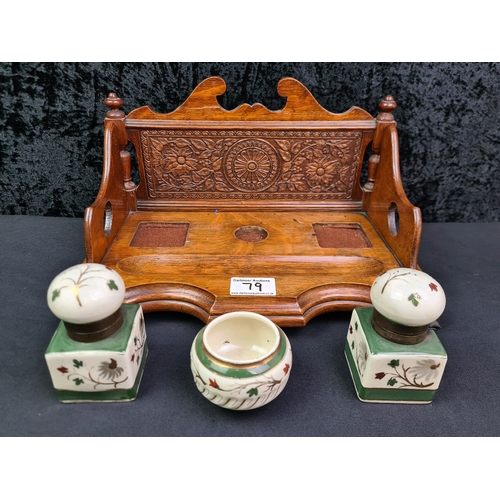 79 - Wooden desk stand with intricately carved back and fitted ceramic dish and inkwells