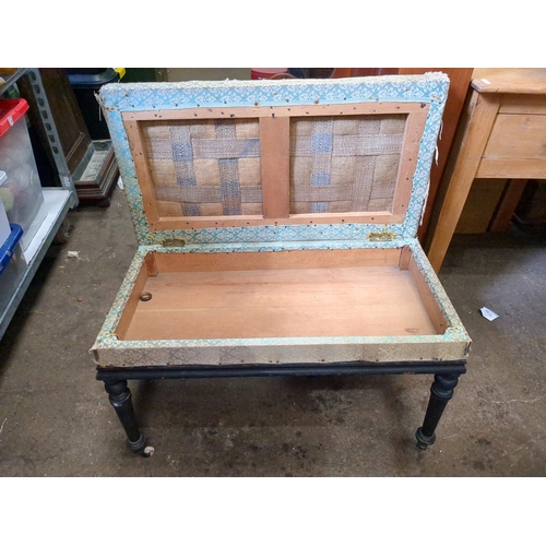 932 - Antique upholstered double piano stool with lift up lid.  Missing one castor.