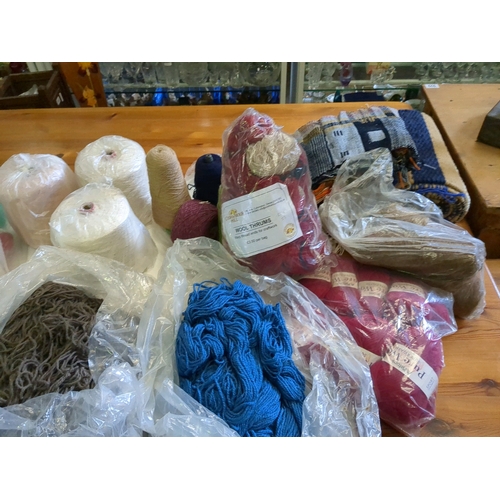 939C - Large plastic wheeled storage container full to the brim with various wools and yarns, some Aran wei... 