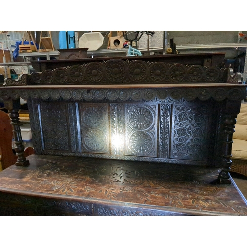 958 - Dark oak sideboard in a Tudor style.  Various shakes and splits to the boards along with signs of ro... 