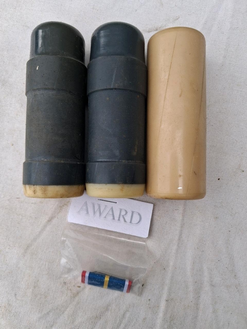 Three rubber bullets and a ribbon