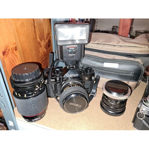 Two Canon cameras plus lenses, extra kit and carry cases.
