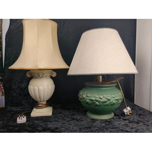 129 - Large green ceramic lamp base with matching shade along with a cream urn style lamp base and shade.
