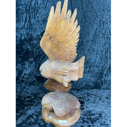 144 - Impressive hand-carved wooden sculpture featuring two owls, one perched on a base and the other in f... 