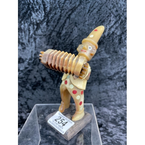 254 - Charming vintage jester/clown figurine playing an accordian, made from bone. Approx H16cm.