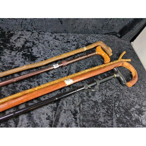 350 - Two metal and three wooden walking sticks, very useful for a hike up the Tor!