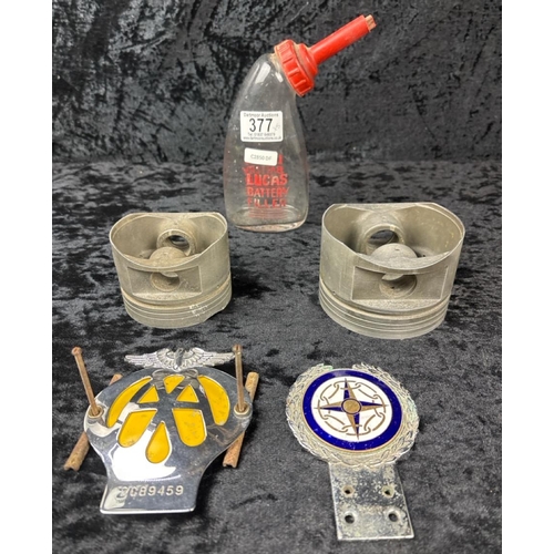 377 - Lucas battery filler, AA car badge, a car club car badge and two forged pistons.