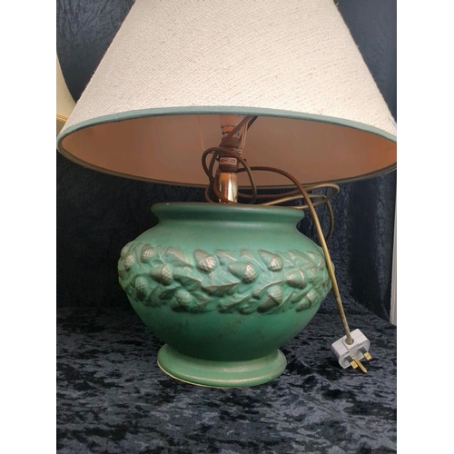 129 - Large green ceramic lamp base with matching shade along with a cream urn style lamp base and shade.