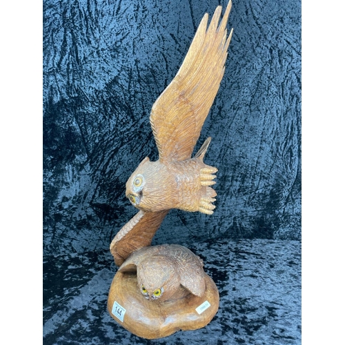 144 - Impressive hand-carved wooden sculpture featuring two owls, one perched on a base and the other in f... 