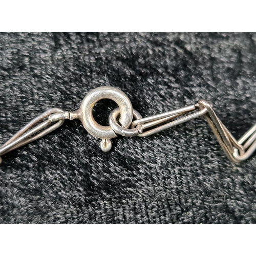 628 - Unmarked white bracelet (clasp a/f) and a silver mounted pendant on a white metal chain