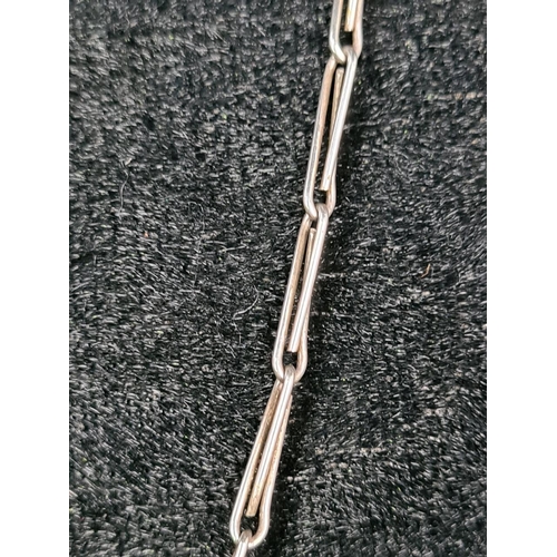 628 - Unmarked white bracelet (clasp a/f) and a silver mounted pendant on a white metal chain