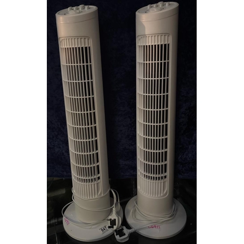 947 - Two floor-standing column fans. Approx H76cm.