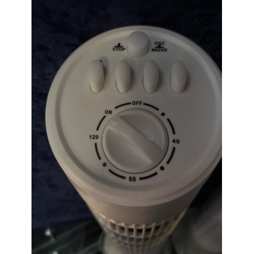 947 - Two floor-standing column fans. Approx H76cm.
