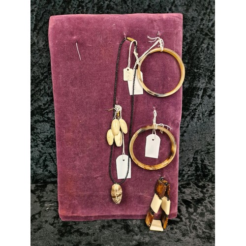 523 - Two velvet cushioned collections of earrings, bangles and a necklace.