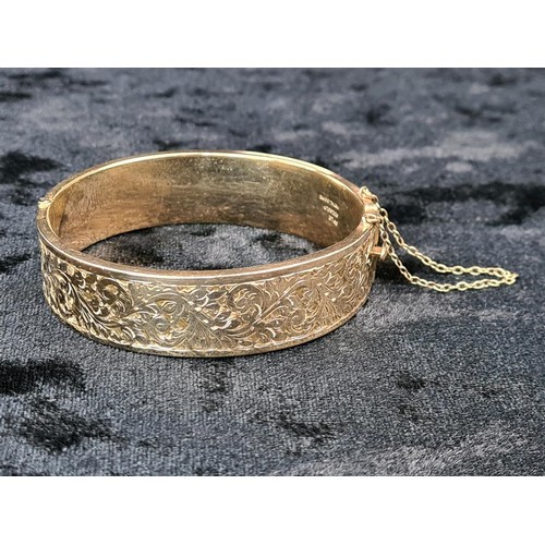 623 - 9ct gold plated decorative hinged bangle with security chain