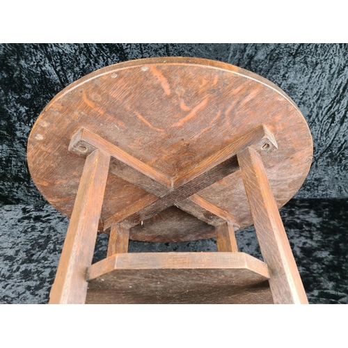 105 - Arts and Crafts circular oak lamp table with an octagonal undertier and an X-frame base. Approx H58c... 