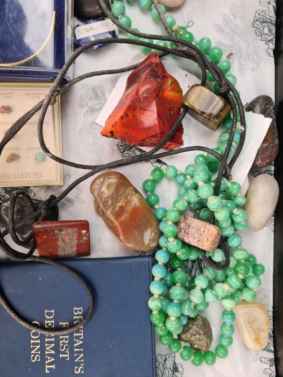 Collection of semi precious stones including a sample box, gold plated ...