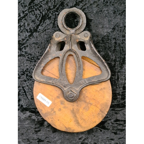 84 - Antique Louden A21 cast iron and wood wheel barn pulley, used for handling hay bales. Approx H26cm.