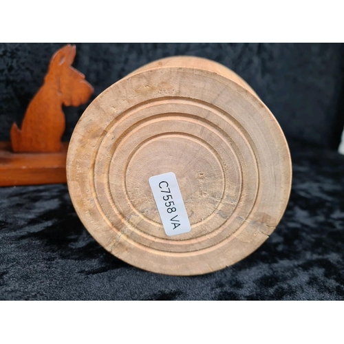 87 - Three hand-carved wooden pieces including a vintage pair of Scottie dog bookends and two lidded trin... 