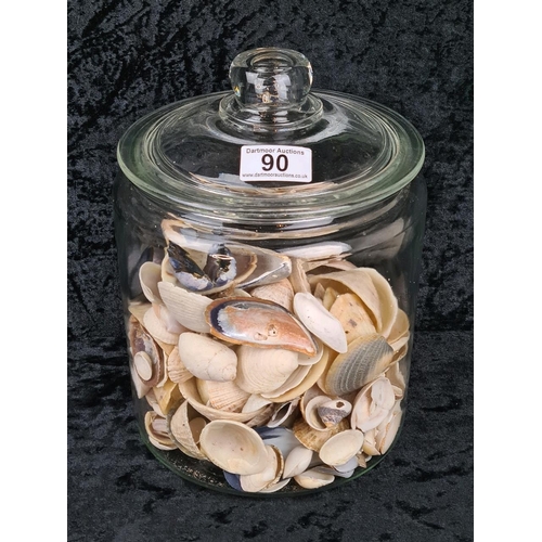 90 - Large glass lidded jar full of shells.