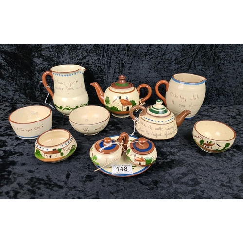148 - Collectible Devon Motto-ware including teapots, bowls and jugs - nine pieces in all.
