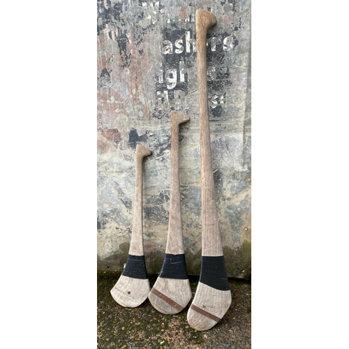 252 - Three vintage Shinty sticks of different sizes.