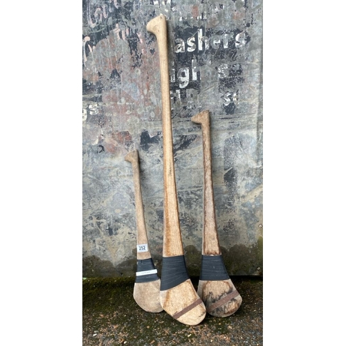 252 - Three vintage Shinty sticks of different sizes.