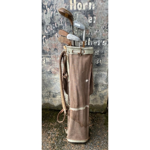 253 - Antique set of golf clubs in original bag.