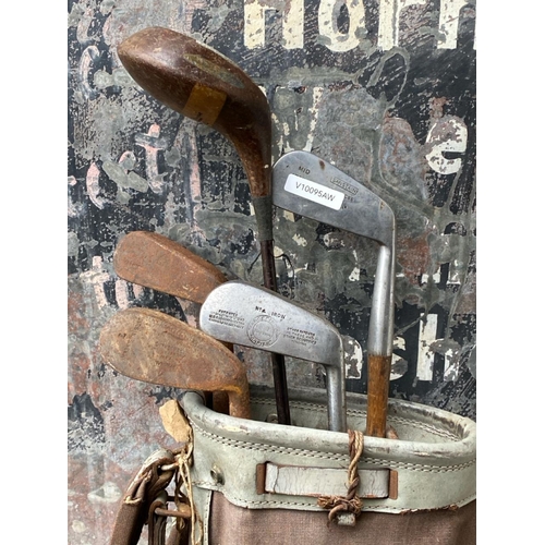 253 - Antique set of golf clubs in original bag.