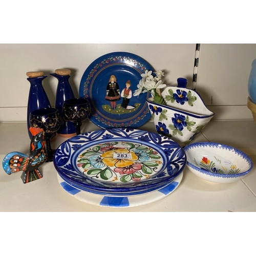 283 - Collection of blue kitchenalia and trinkets including a pottery wall pocket, glasses, oil pourers, h... 
