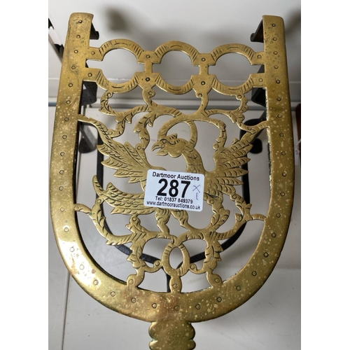 287 - Antique 18th century tripod trivet with hand forged cast iron legs and brass plate intricately decor... 