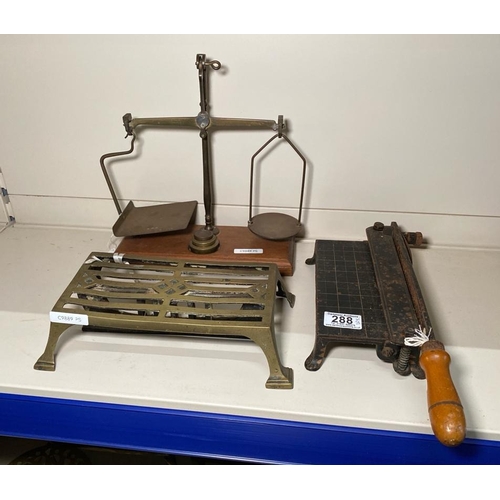 288 - Antique brass and cast iron trivet, set of GPO scales with weights and a small antique guillotine.