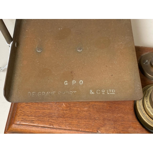 288 - Antique brass and cast iron trivet, set of GPO scales with weights and a small antique guillotine.