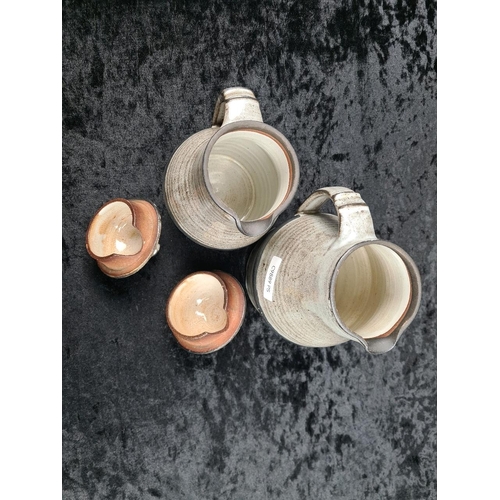 322 - Two studio Pottery tea pots, (makers’ mark to base of handle), Vellow pottery coffee pot, pale blue ... 