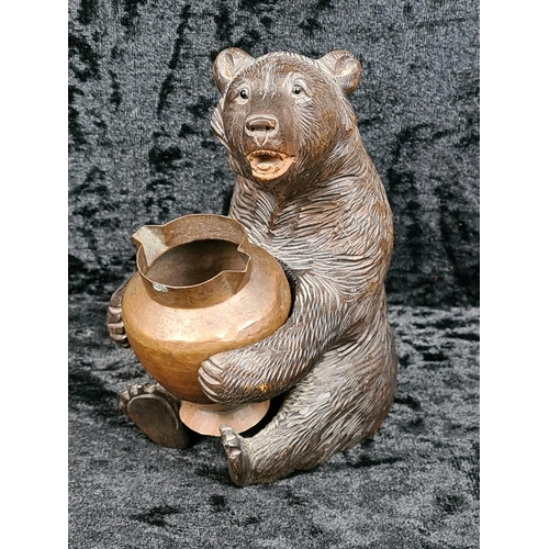 335 - Black Forest style carved brown bear holding a copper pot approx H12cm
