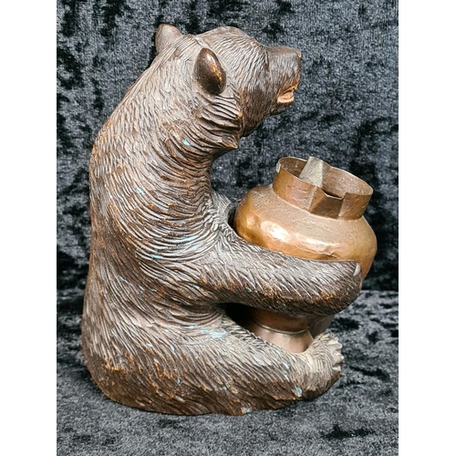 335 - Black Forest style carved brown bear holding a copper pot approx H12cm