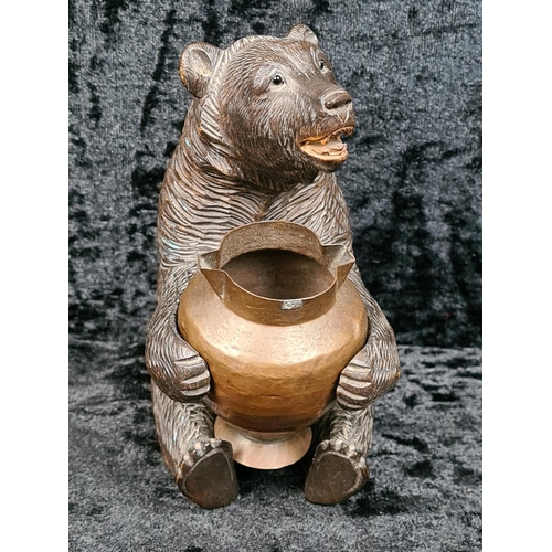 335 - Black Forest style carved brown bear holding a copper pot approx H12cm