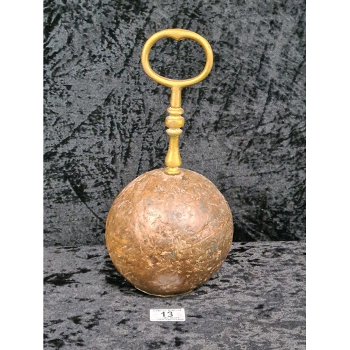 13 - Round mahogany doorstop with ornate brass handle. Approx H30cm.